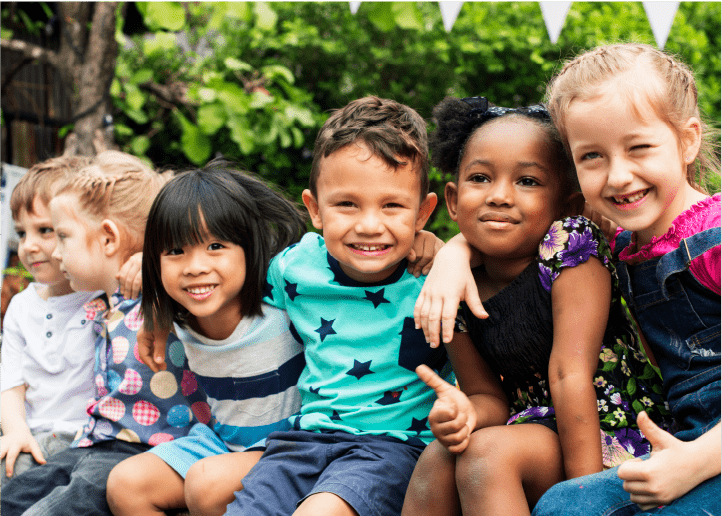 Diverse group of children embracing, arms over shoulders
