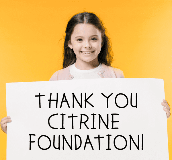 Little girl holding sign that says Thank you Citrine Foundation